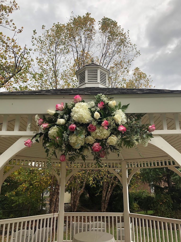Beautifully adorned gazebo ceiling, setup for an outdoor wedding ceremony in Springmill Manor venue
